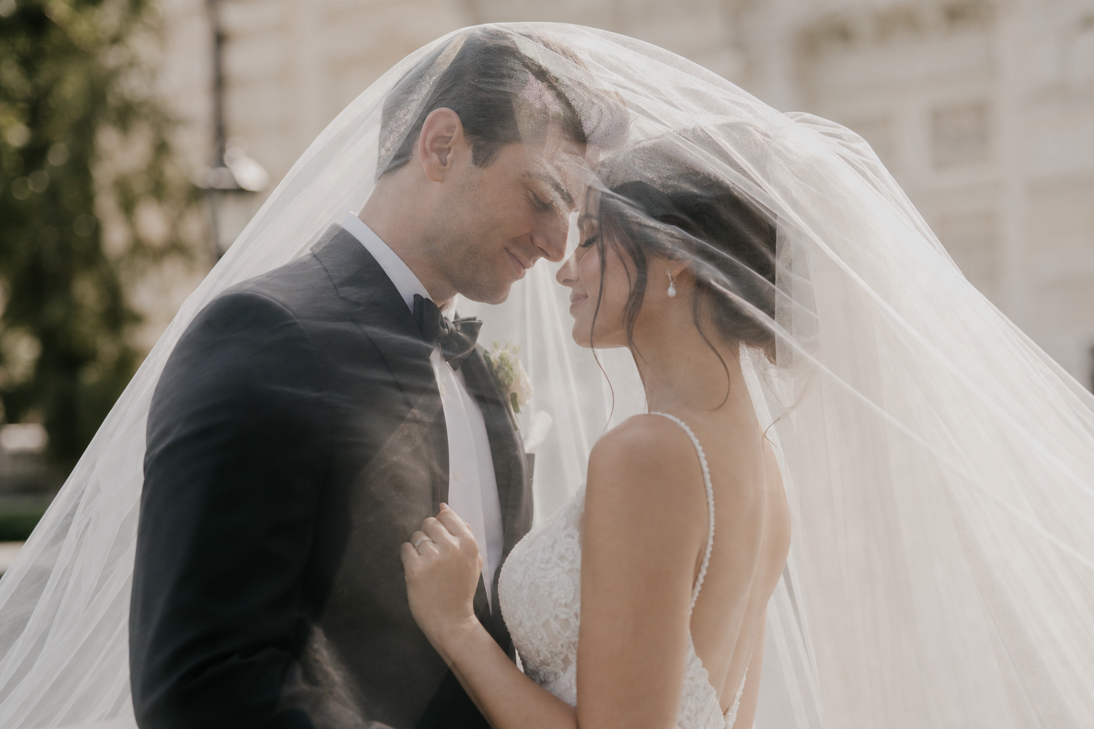 Bride and groom in an elegant veil portrait